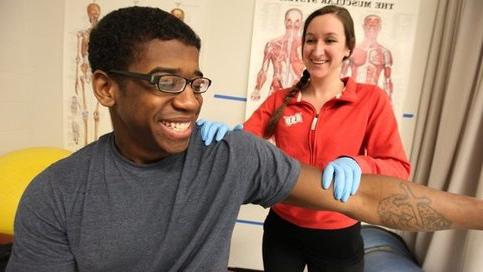Athletic training student with patient